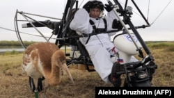 Russian President Vladimir Putin prepares to take part in a scientific experiment as part of the "Flight of Hope," which aims to preserve a rare species of cranes, in September 2012.