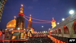 Muslim Shi'ite pilgrims gather outside the Imam Abbas shrine in Karbala on February 4.