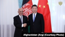 Afghan President Ashraf Ghani (right) greets his Chinese counterpart, Xi Jinping, in Kyrgyzstan, in June 2019.