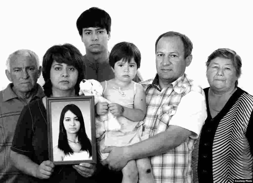 The Kusov family with a portrait of Anzhela - Her family called her Zyozya. On the first day of school she went with her former classmates, her cousin Aslan and her best friend Diana. Her parents were in Moscow at the time. Anzhela and Diana were killed; Aslan was seriously wounded. In the gym, Anzhela helped the children, giving them cloths soaked in urine so they could somehow quench their thirst. One of the terrorists shouted, "Don't you understand that you have to sit quietly?" and he wanted to shoot. He heard us laugh and say, "Well, go ahead and shoot. What are you standing there for?"