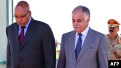 Libyan Prime Minister Baghdadi al-Mahmudi (right) welcomes South African President Jacob Zuma upon his arrival in Tripoli on May 30.