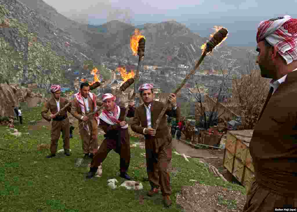 Iraqi Kurds mark Norouz with a torch-lit procession up a mountain above the town of Aqrah, some 100 kilometers east of Mosul.