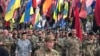 Thousands of Ukrainians march through Kyiv under flags and banners of right-wing and nationalist groups on October 14 as part of ceremonies marking the Defenders Day holiday.