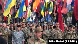 Thousands of Ukrainians march through Kyiv under flags and banners of right-wing and nationalist groups on October 14 as part of ceremonies marking the Defenders Day holiday.