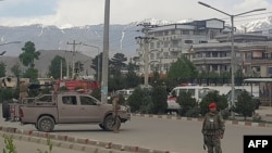 Afghan security personnel arrive at the scene of an attack near the Marshal Fahim Military Academy in Kabul on May 30.