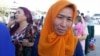 Kyrgyz women wait to cross into Uzbekistan at the Dostyk border crossing, the first to reopen following an agreement signed by the Uzbek and Kyrgyz presidents earlier this month.