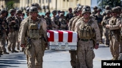 US soldiers act as pallbearers for the 13 service members killed in a bombing at Kabul airport in August 2021. 