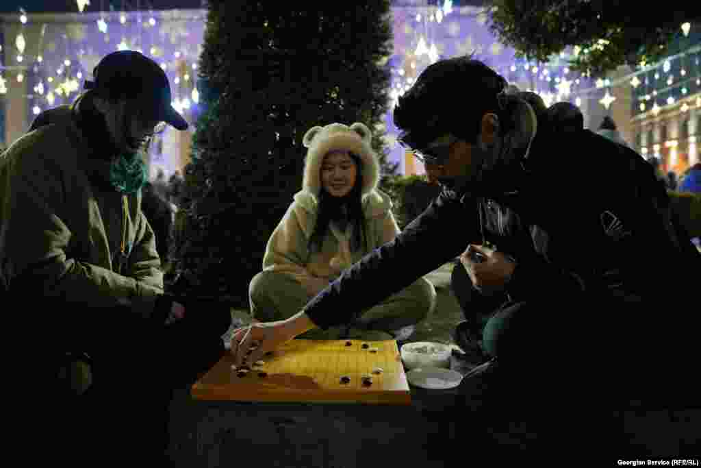 Protesters play the strategy board game Go amid protests on Rustaveli Avenue on January 13.&nbsp;