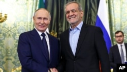 Russian President Vladimir Putin and Iranian President Masud Pezeshkian pose for a photo prior to talks at the Kremlin in Moscow on January 17.