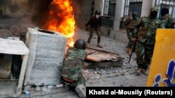 Iraqi security forces clash with demonstrators during anti-government protests in Baghdad on November 26.