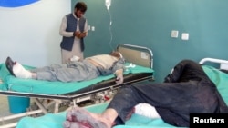 Afghan men receive treatment at a hospital after suicide bombers and gunmen attacked a provincial Afghan police headquarters in Gardez on October 17.