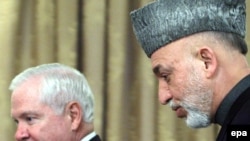 Afghan President Hamid Karzai (right) and U.S. Defense Secretary Robert Gates speak with journalists in Kabul today.