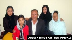 Mohammad Kabir Anwari, and his wife, Rabia (right), pose with three of their six daughters at their home in western Kabul.