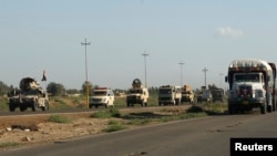 Iraqi troops travel in military vehicles towards Hawija, near Kirkuk on April 23