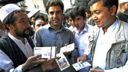 Money traders at a change market in Herat on October 4.