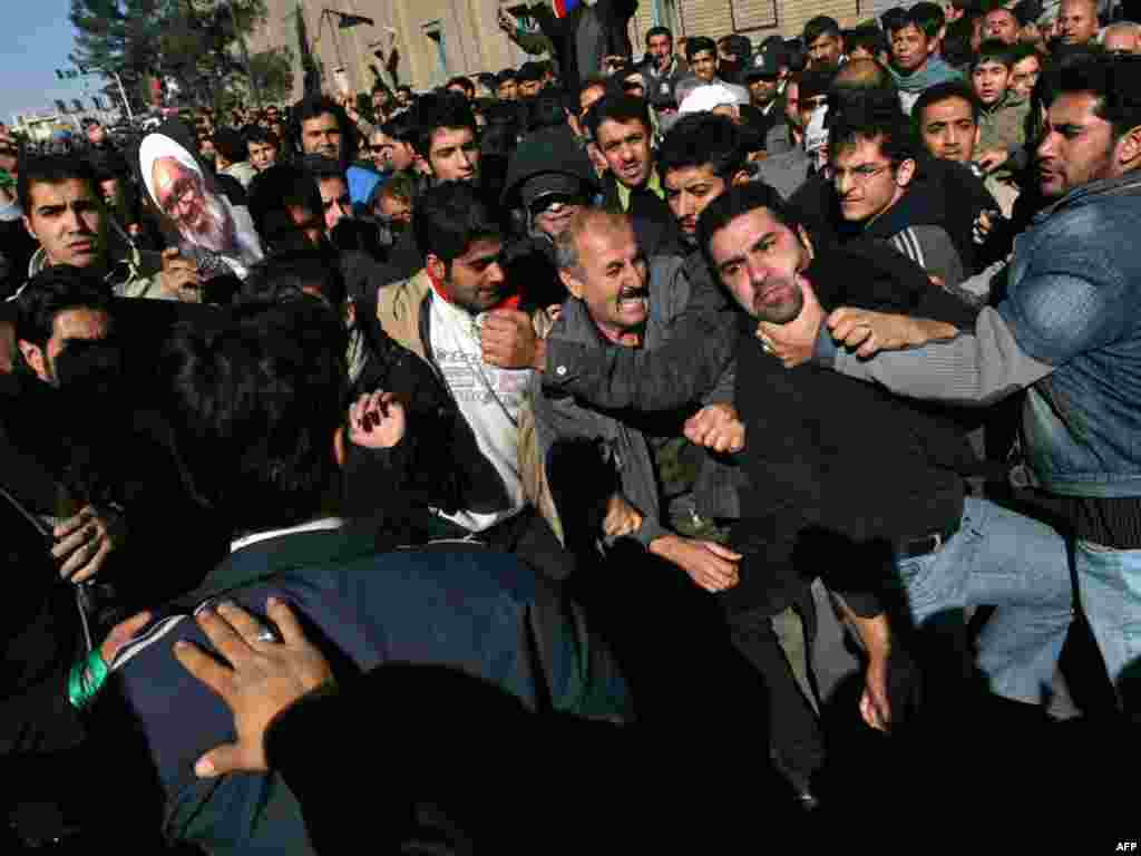 Opposition activists and supporters of Supreme Leader Ayatollah Ali Khamenei clash during the funeral.