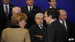 German Chancellor Angela Merkel (left) and European Commission President Jose Manuel Barroso speak prior to a photo opportunity during a European Union summit at EU headquarters in Brussels in January.