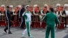 Turkmen President Gurbanguly Berdymukhamedov (center) waves to the media during the starting ceremony in May 2016 for a 500-day nationwide horse race, which was organized as part of Ashgabat's elaborate preparations for the 2017 Asian Indoor and Martial Arts Games.