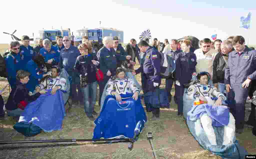 Acaba (left), Padalka (center) and Revin meet the press shortly after landing.