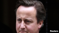 Britain's Prime Minister David Cameron leaves 10 Downing Street in London to appear before Parliament on July 20.