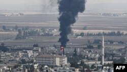 A photo from the Turkish side of the border at Ceylanpinar district in Sanliurfa shows fire and smoke rising from the Syrian town of Ras al-Ain on October 18.