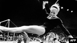 Czech athlete Vera Caslavska celebrates one of her triumphs at the 1968 Olympic Games in Mexico. She is still the only gymnast to have won Olympic gold medals in every individual event. 