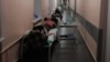 Patients lie in the corridor of a hospital in Vologda in northern Russia. 