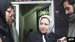 Shirin Ebadi (center) speaks to journalists as she leaves the Center of Human Rights Defenders after Iranian police closed its doors on December 21.