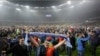 Dnipro Dnipropetrovsk's fans storm the field in celebration after their team's semifinal match against Napoli in Kyiv on May 14.