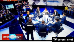 Eventually, the talk show's host called for support and two policemen entered the studio, flanking nationalist politician Volen Siderov.