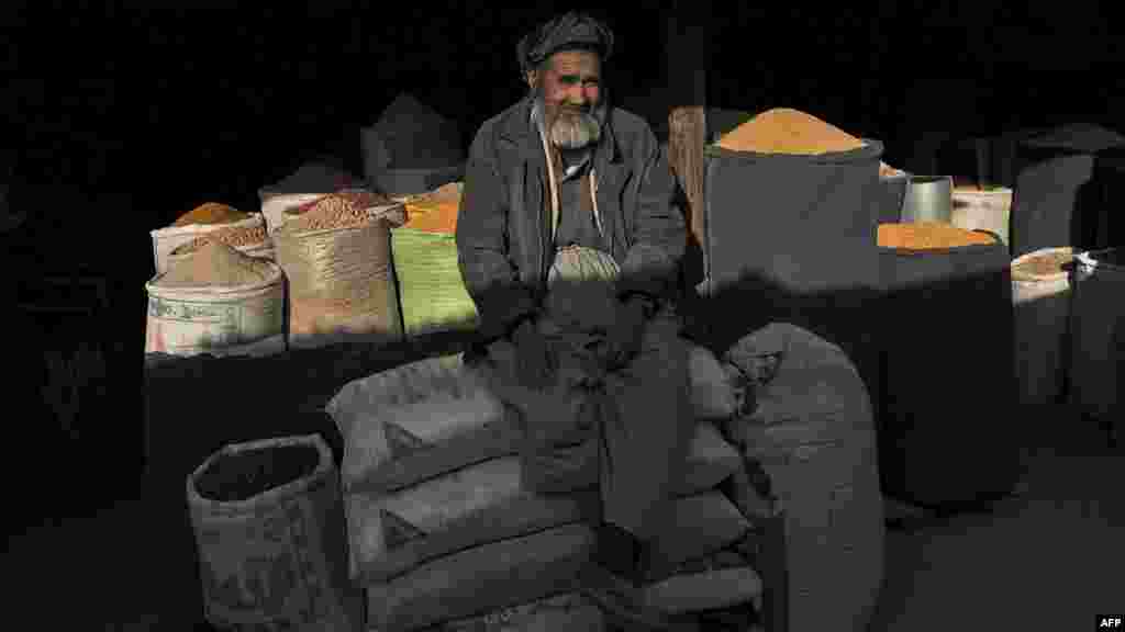 An elderly vendor sits at his shop in Kabul in April.