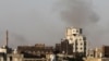 Smoke rises over the Yemeni capital, Sanaa, after the city's airport was hit by Israeli air strikes on December 26