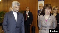 EU foreign policy chief Catherine Ashton (right) greets Iran's chief nuclear negotiator Said Jalili (left) in Geneva.