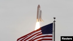 The space shuttle "Atlantis" lifts off from the Kennedy Space Center in Cape Canaveral, Florida, for the final mission of the shuttle program.