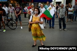 Voters attend a weekly demonstration against corruption in front of the Palace of Justice building in Sofia on July 7. The interim government formed in May by President Rumen Radev has drawn attention to cases of alleged corruption and abuse of power under the previous GERB-led government.