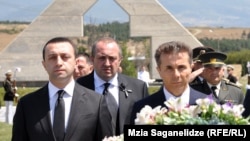 Some analysts fear that billionaire Bidzina Ivanishvili (right) may have something to do with tensions between Georgian Prime Minister Irakli Garibashvili (left) and the country's President Giorgi Margvelashvili (center -- file photo)