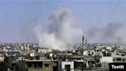 Smoke rises following purported shelling in Homs on April 10.