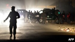 Afghan police patrol and inspect the site of an attack that appeared to target foreign troops or workers in Kabul on October 18.