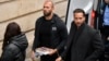 Andrew Tate (center) and his brother Tristan (right) are brought by police officers to the Court of Appeal in Bucharest on January 10.