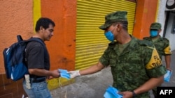 Mexican soldiers distribute face masks as prevention against the swine-flu virus in Mexico City.