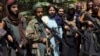 Taliban fighters pose for photograph in Kabul's Wazir Akbar Khan neighborhood on August 18.