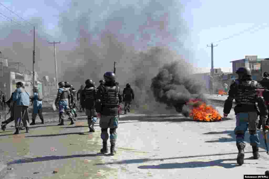 Security forces try to disperse a protest in Kabul at which tires were being burned.