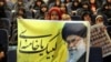 An Iranian girl holds up a portrait of Supreme Leader Ayatollah Ali Khamenei during a campaign meeting for conservatives ahead of upcoming parliamentary elections, which could shape Iran's political landscape for years to come. 