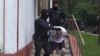 A screenshot from Belarusian state TV showing the arrest of one of dozens of puported Russian mercenaries on July 29. 