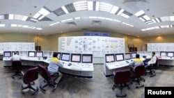 Russian and Iranian operators monitor the nuclear power plant unit at Bushehr.