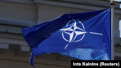 The NATO flag flies over the Lithuanian capital, Vilnius, which is hosting a gathering of the alliance's leaders this week. 