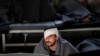 A man suspected of being part of the Islamic State militant group, sits inside a prison hospital in Hasaka, Syria.