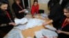 Members of a local electoral commission count ballots at a polling station after a snap parliamentary election in Baku on February 9. 