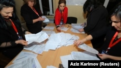 Members of a local electoral commission count ballots at a polling station after a snap parliamentary election in Baku on February 9. 