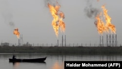 Fames rise from the burning of excess hydrocarbons at a natural gas field north of Basra.